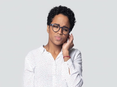 a woman holding her ear in pain